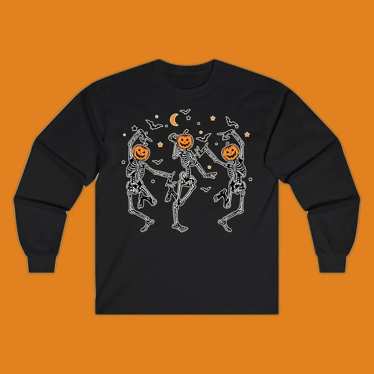 Three dancing skeletons with pumpkin heads, bats, moon, and stars illustration for Halloween.