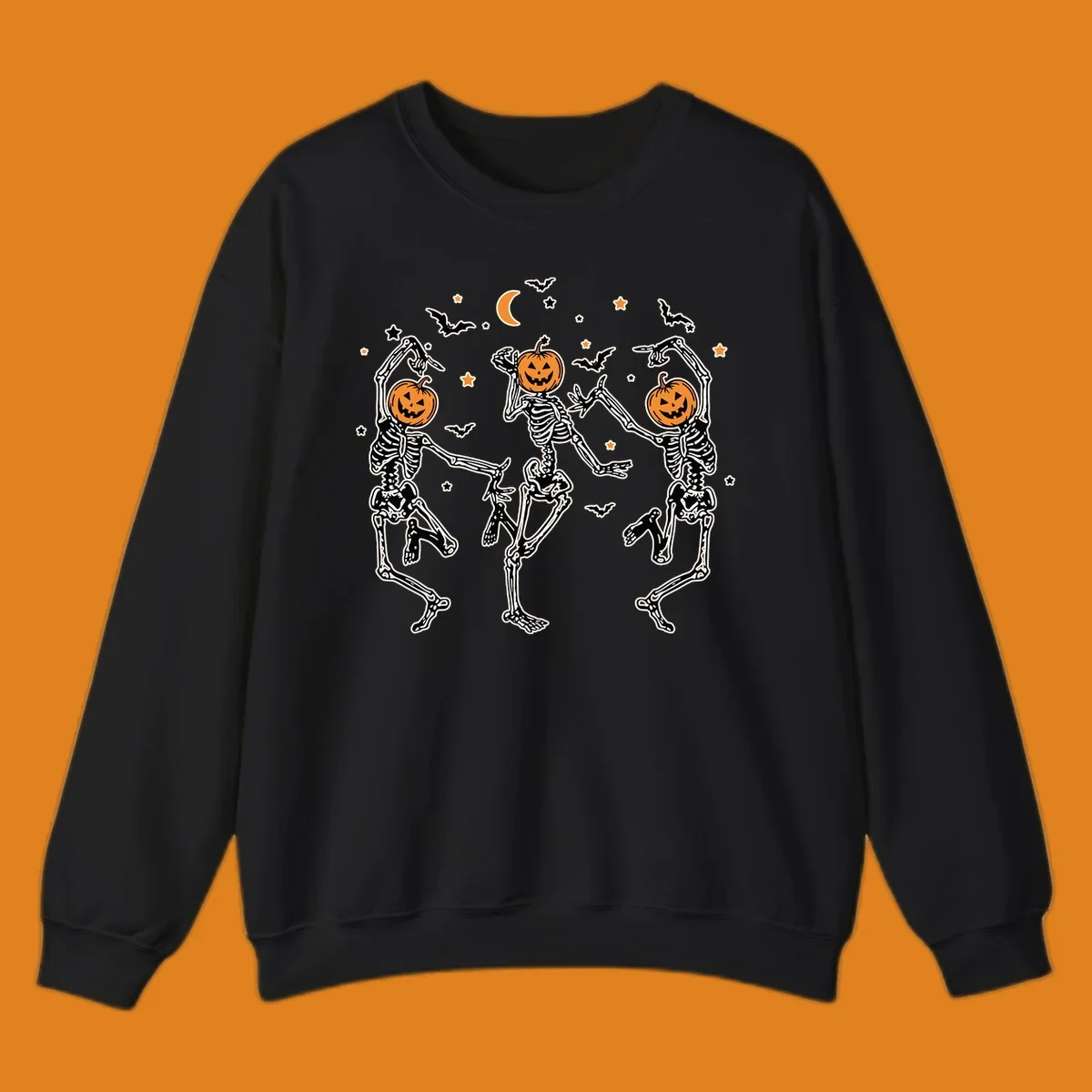 Three dancing skeletons with pumpkin heads, bats, moon, and stars illustration for Halloween.
