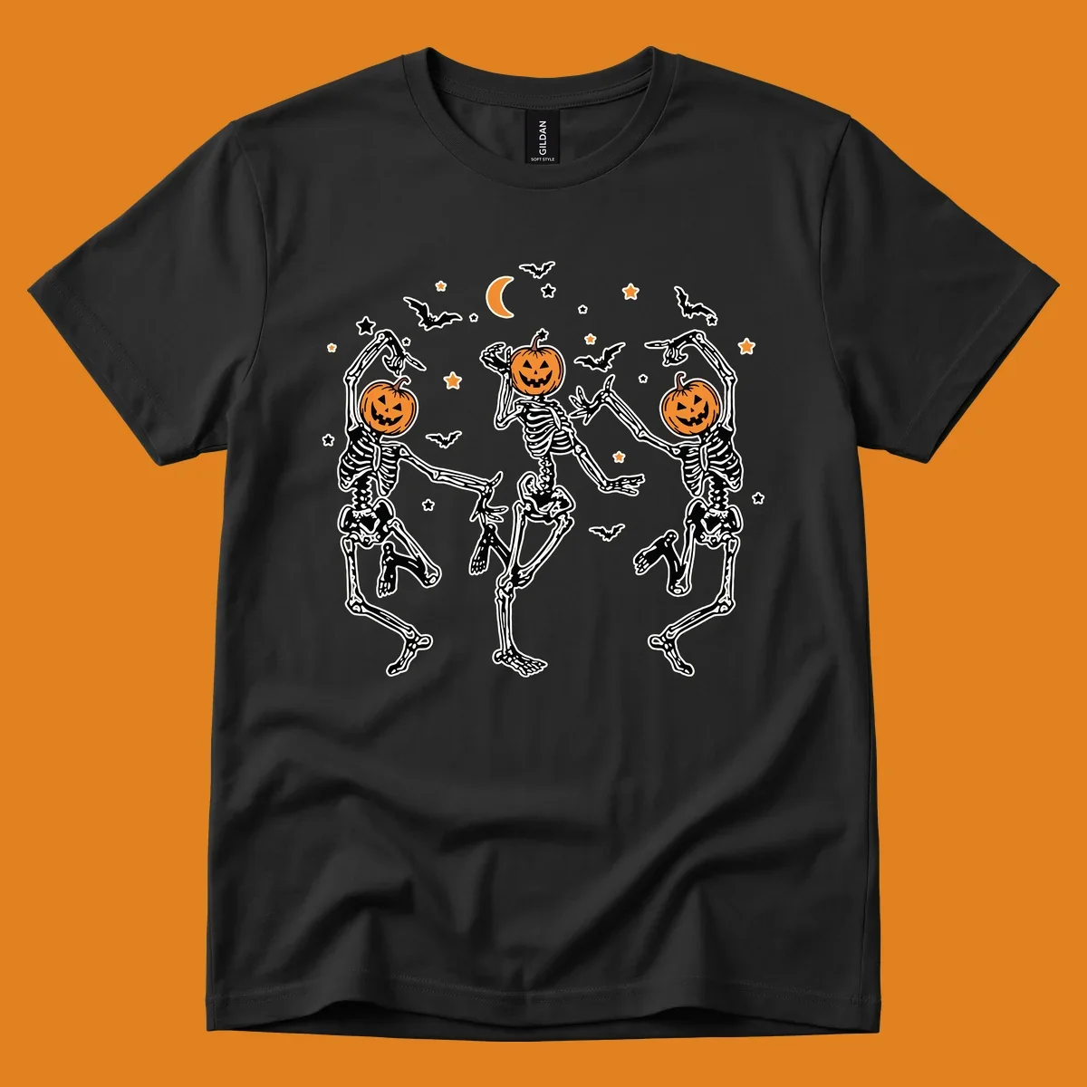 Three dancing skeletons with pumpkin heads, bats, moon, and stars illustration for Halloween.