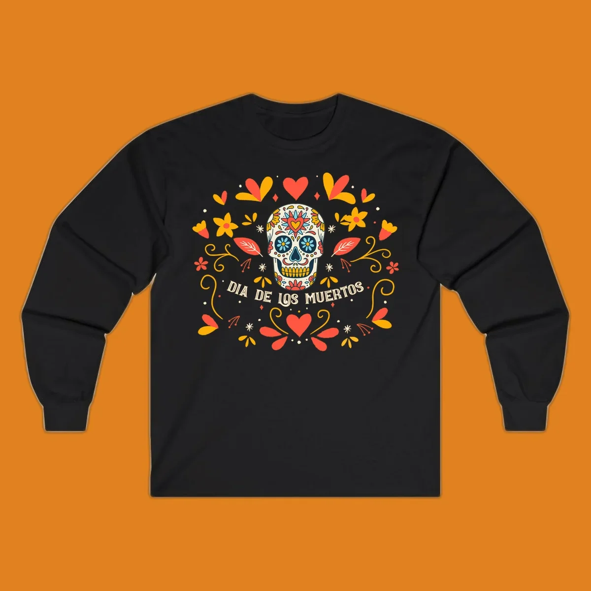 A colorful Día de los Muertos sugar skull with a heart on its forehead, surrounded by a symmetrical frame of red hearts, yellow flowers, and leaves, with 'DIA DE LOS MUERTOS' text below.