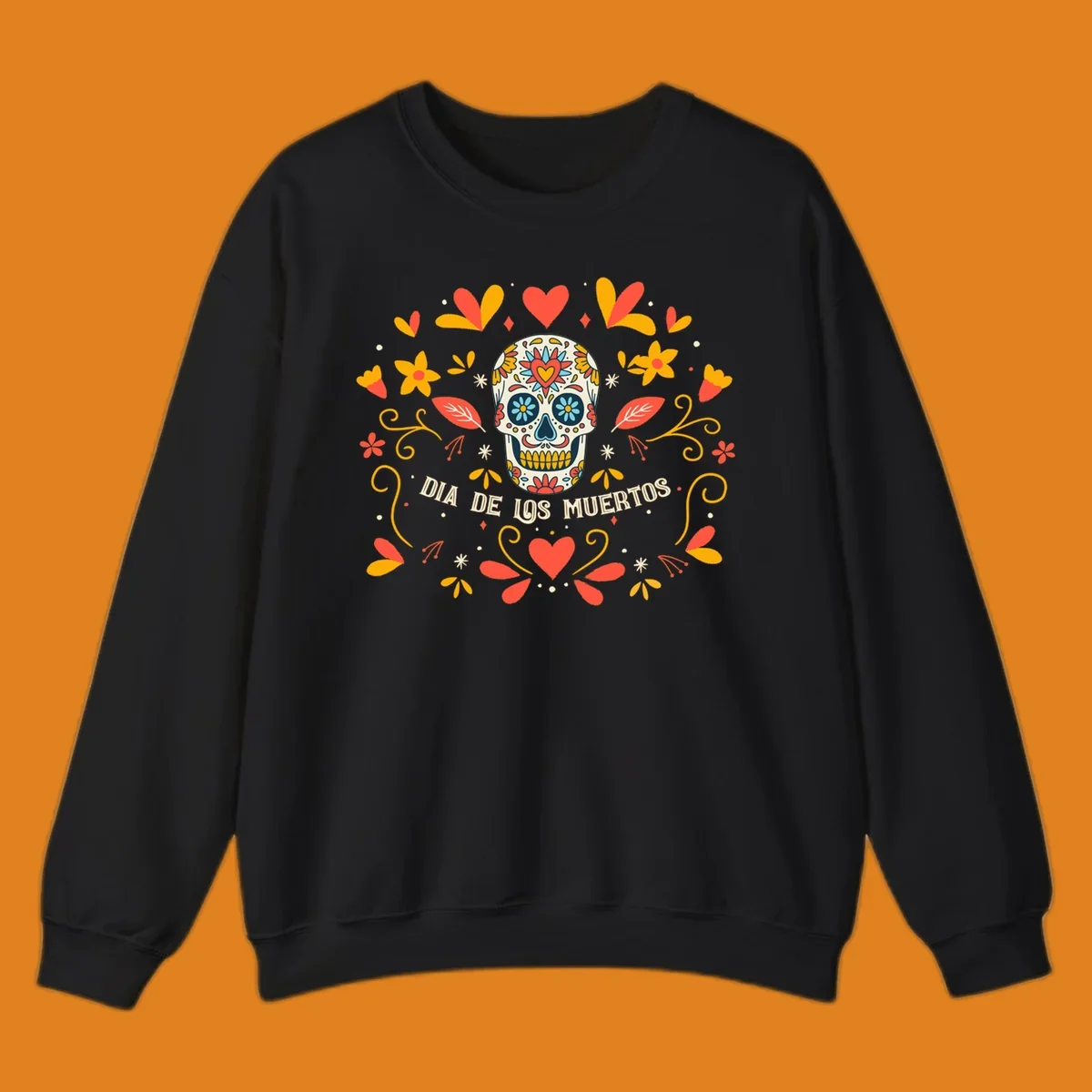 A colorful Día de los Muertos sugar skull with a heart on its forehead, surrounded by a symmetrical frame of red hearts, yellow flowers, and leaves, with 'DIA DE LOS MUERTOS' text below.