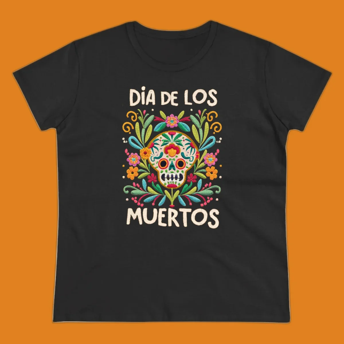 An embroidered-style Día de los Muertos sugar skull with colorful flowers and leaves, and the text "DÍA DE LOS MUERTOS".