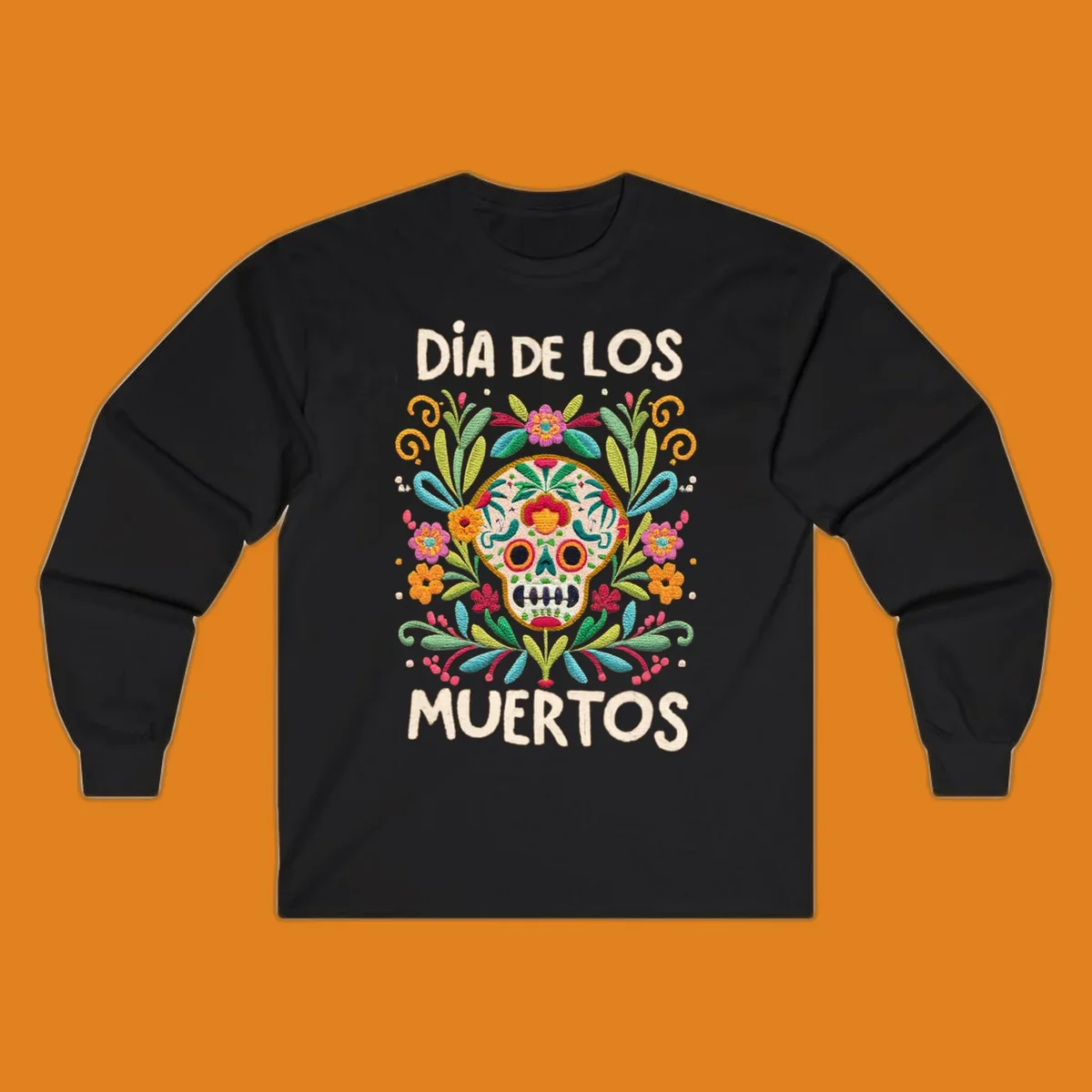 An embroidered-style Día de los Muertos sugar skull with colorful flowers and leaves, and the text "DÍA DE LOS MUERTOS".