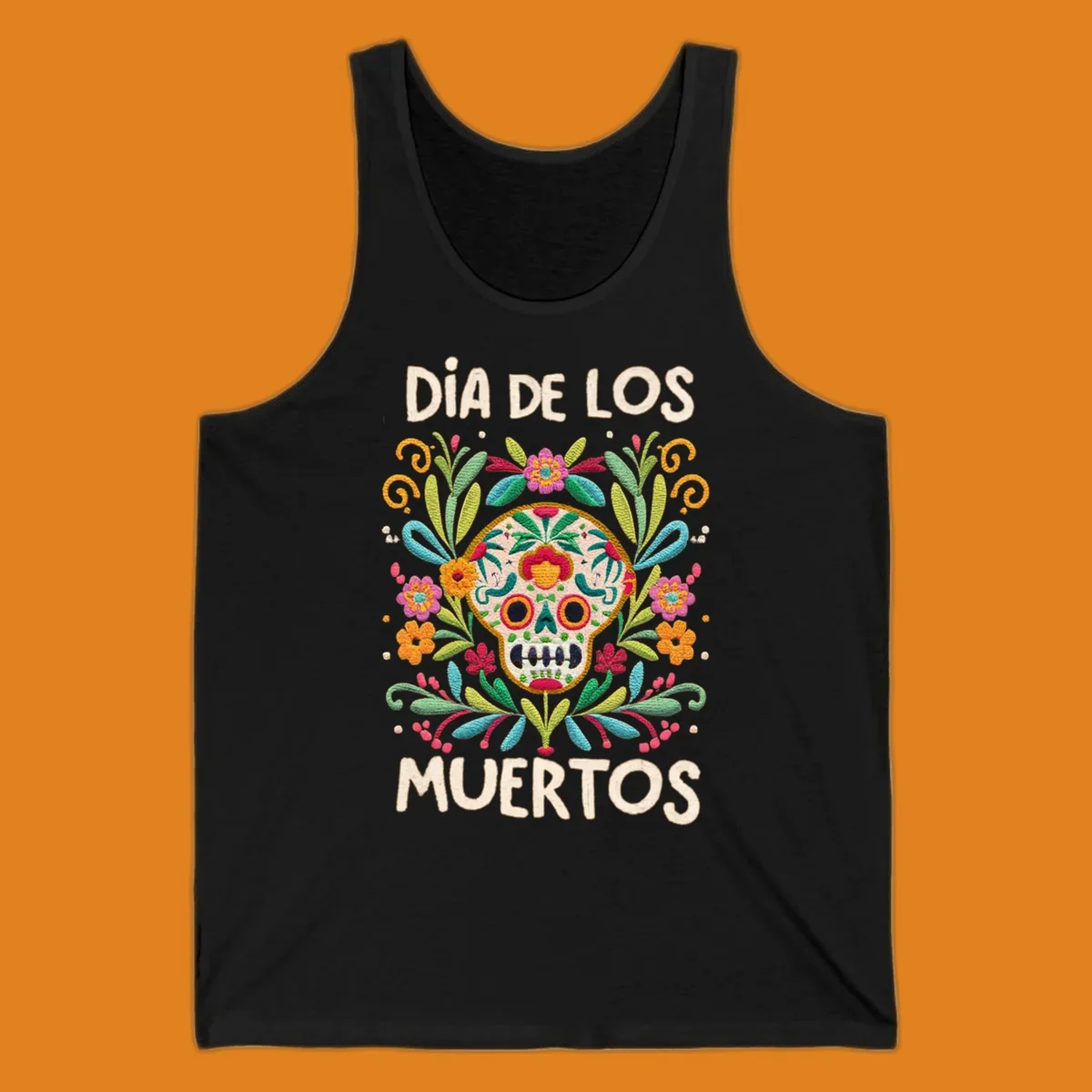 An embroidered-style Día de los Muertos sugar skull with colorful flowers and leaves, and the text "DÍA DE LOS MUERTOS".
