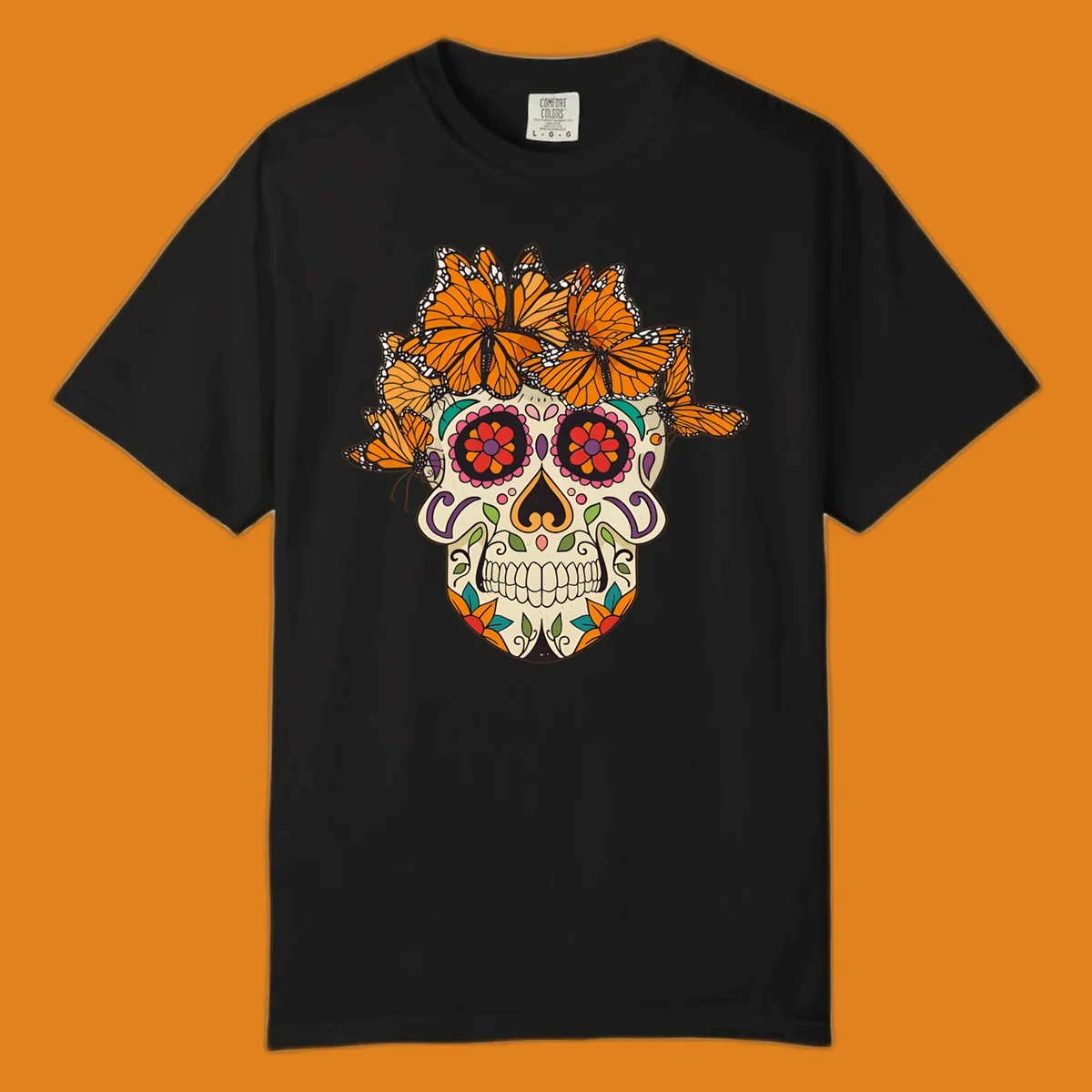 A cream sugar skull with colorful floral patterns and a crown of orange and black monarch butterflies.