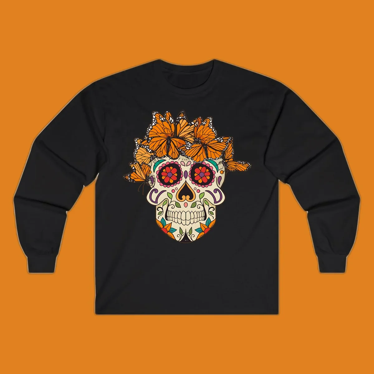 A cream sugar skull with colorful floral patterns and a crown of orange and black monarch butterflies.