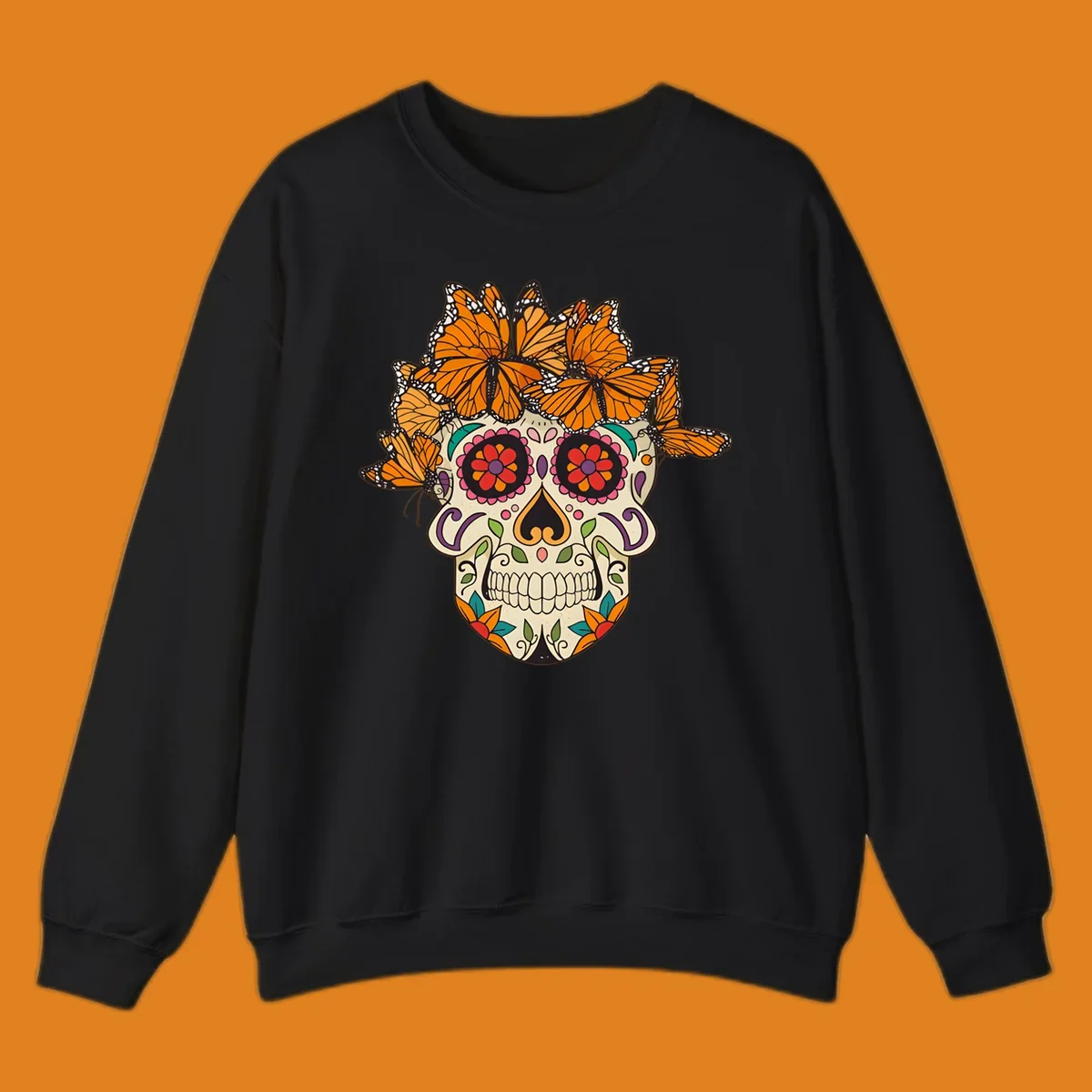 A cream sugar skull with colorful floral patterns and a crown of orange and black monarch butterflies.