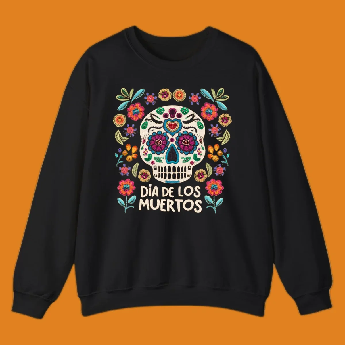 Embroidered-style Día de los Muertos sugar skull with colorful flowers and leaves, and text 'DÍA DE LOS MUERTOS'.