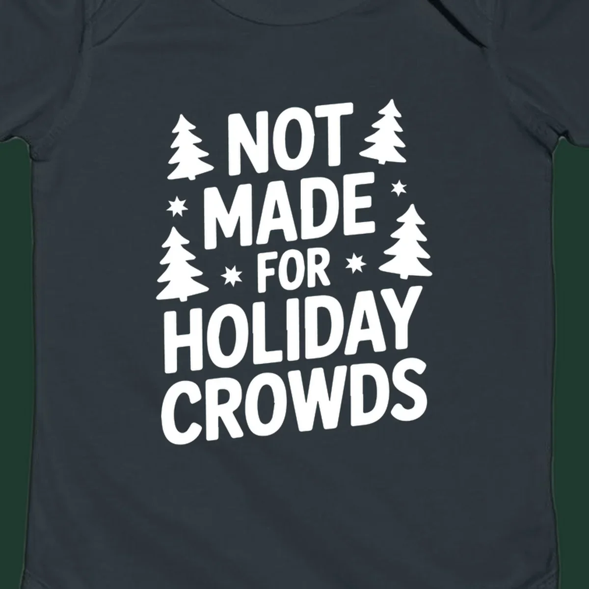 Typography design with 'NOT MADE FOR HOLIDAY CROWDS' text, Christmas trees, and stars.