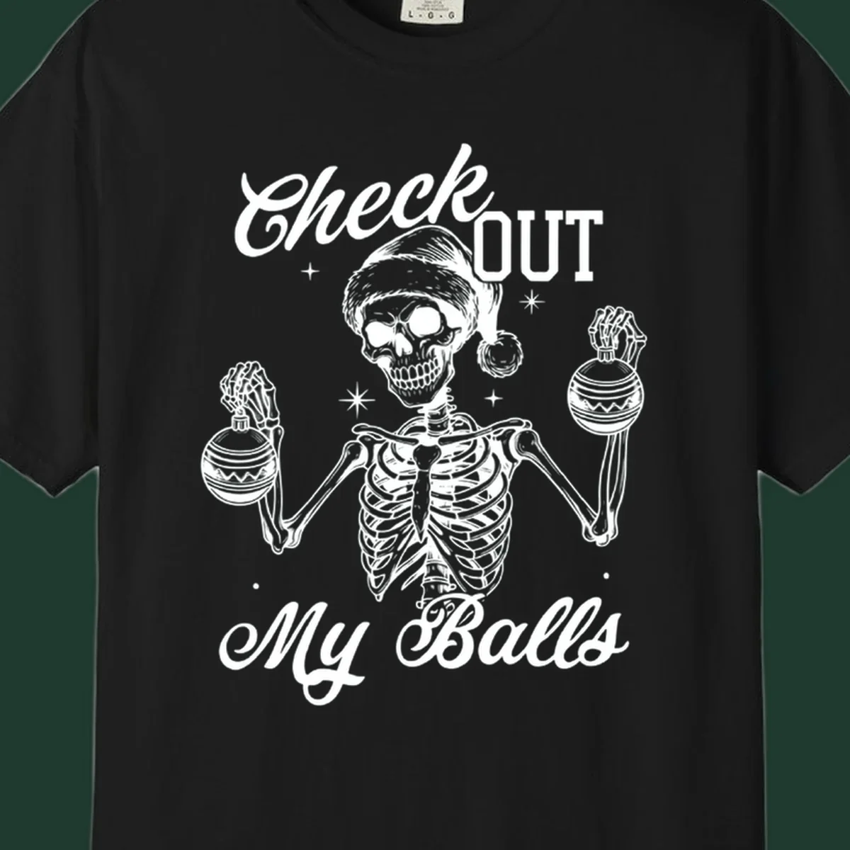 Skeleton wearing a Santa hat and holding Christmas ornaments, with text 'Check OUT My Balls'.