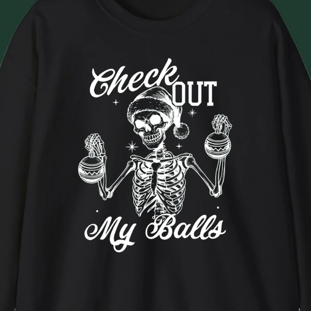 Skeleton wearing a Santa hat and holding Christmas ornaments, with text 'Check OUT My Balls'.