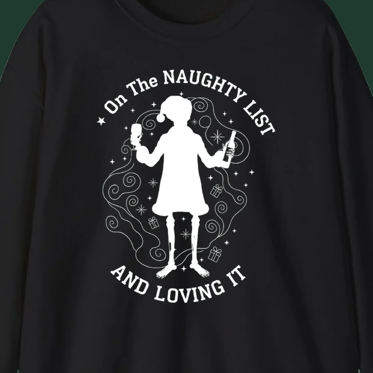 Silhouette of person in Santa hat holding wine, text 'Naughty List And Loving It'.