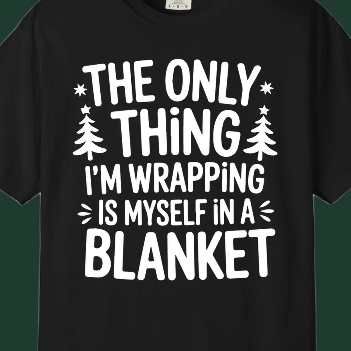 The Only Thing I'm Wrapping Is Myself In A Blanket text design with stars and Christmas trees.