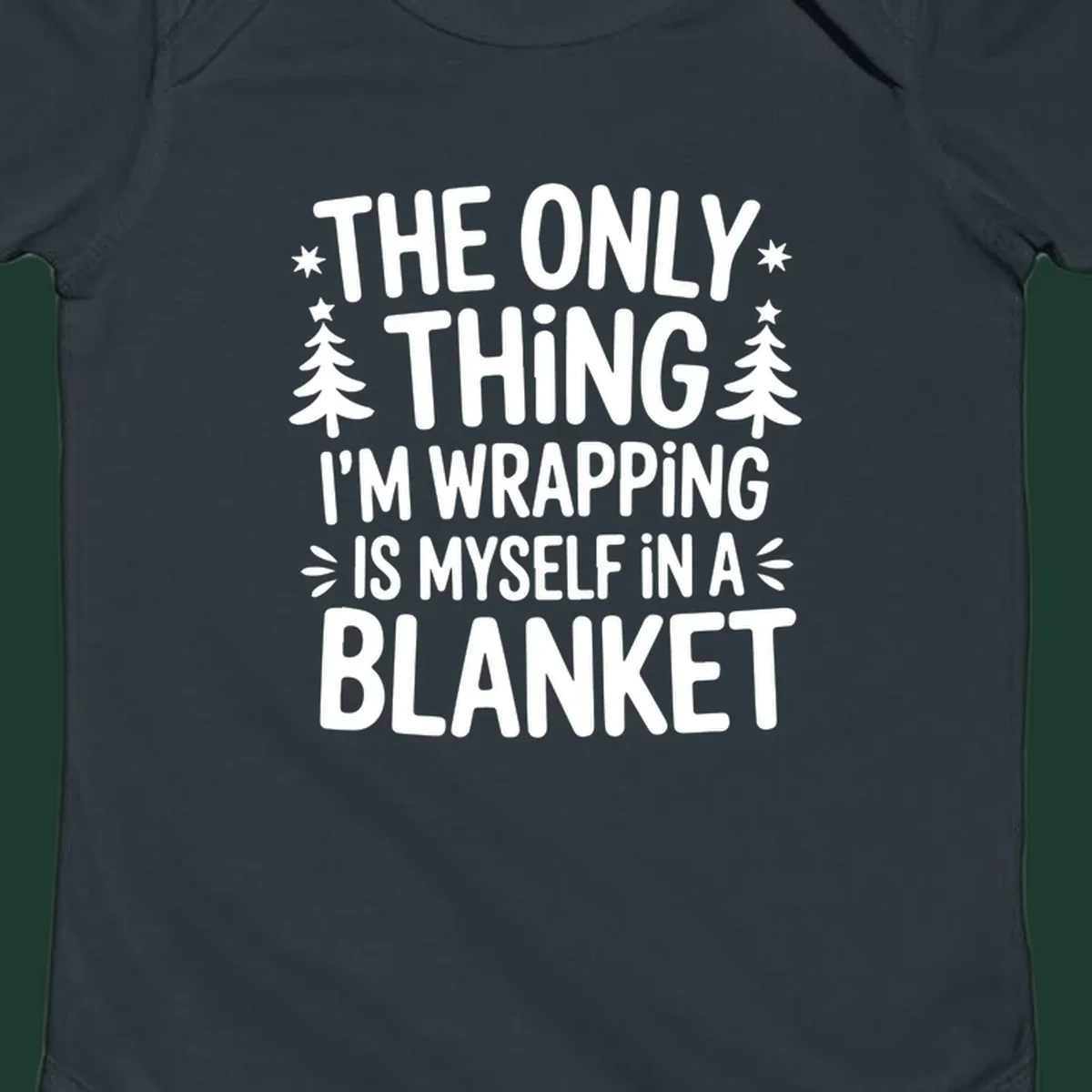 The Only Thing I'm Wrapping Is Myself In A Blanket text design with stars and Christmas trees.