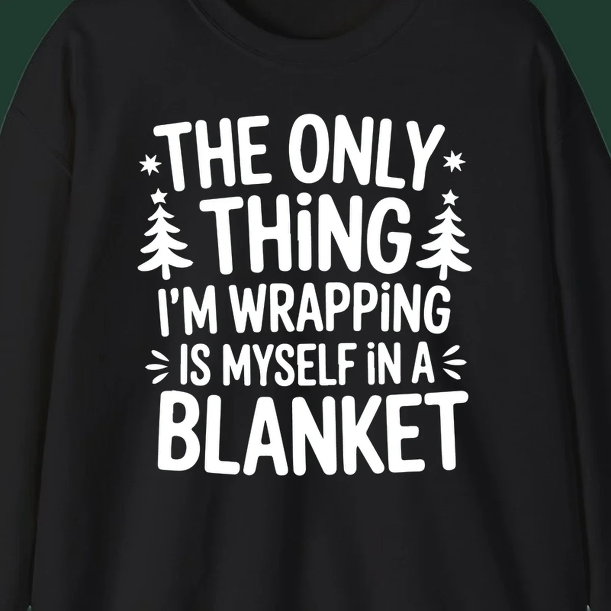 The Only Thing I'm Wrapping Is Myself In A Blanket text design with stars and Christmas trees.