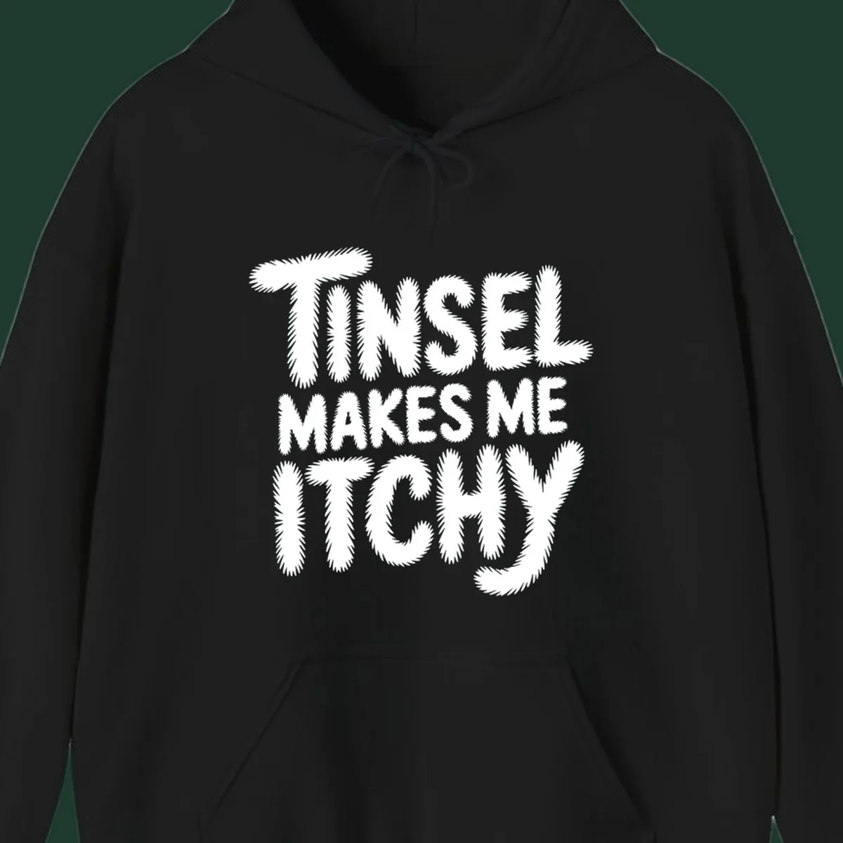 Text design reading "Tinsel Makes Me Itchy" in a fuzzy font.