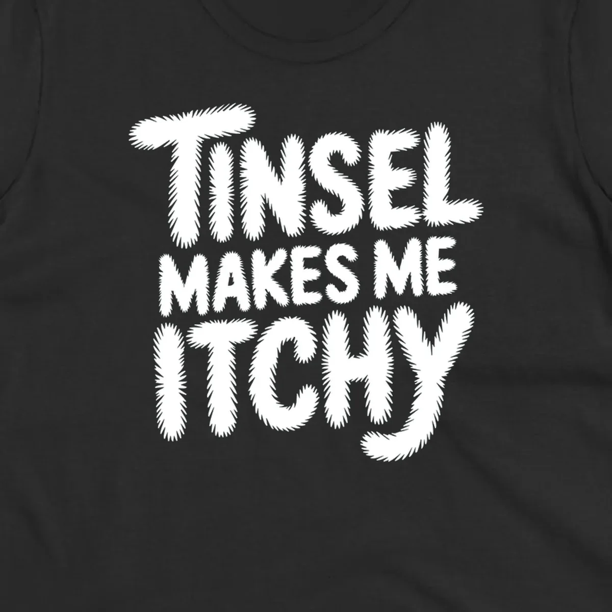 Text design reading "Tinsel Makes Me Itchy" in a fuzzy font.