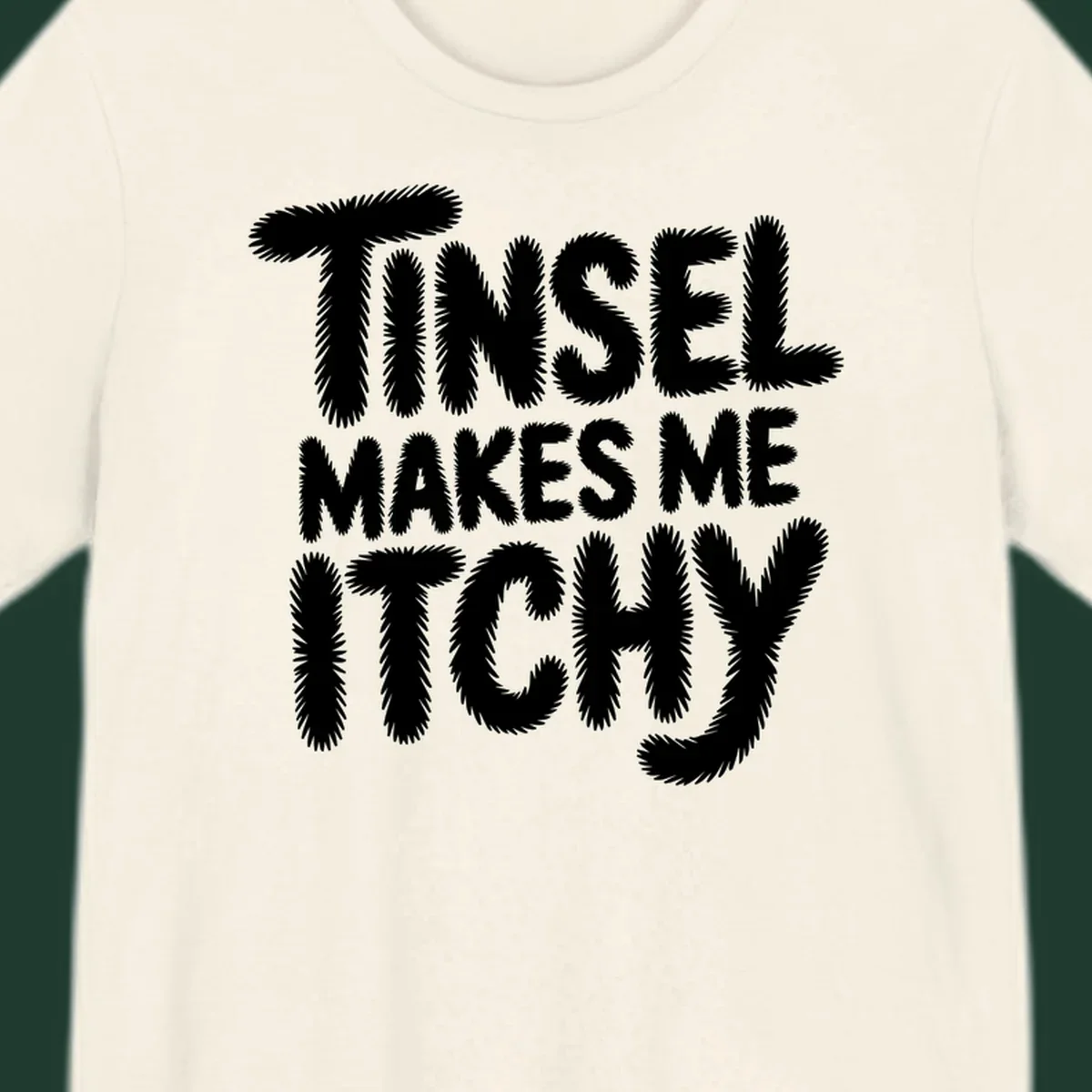 Text design reading "Tinsel Makes Me Itchy" in a fuzzy font.