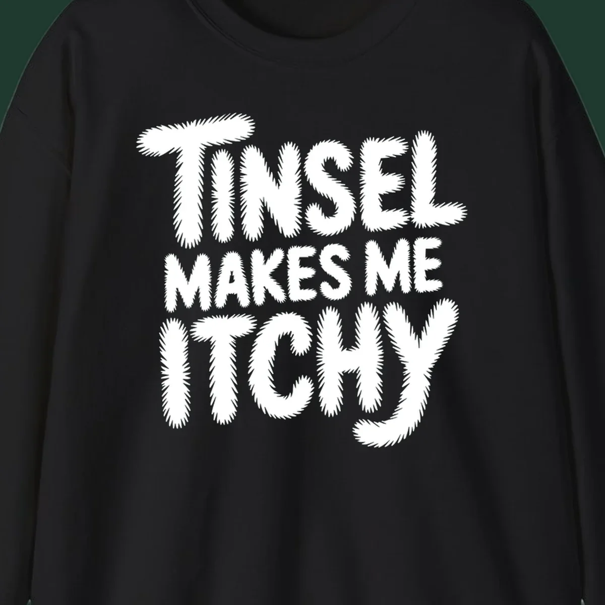 Text design reading "Tinsel Makes Me Itchy" in a fuzzy font.