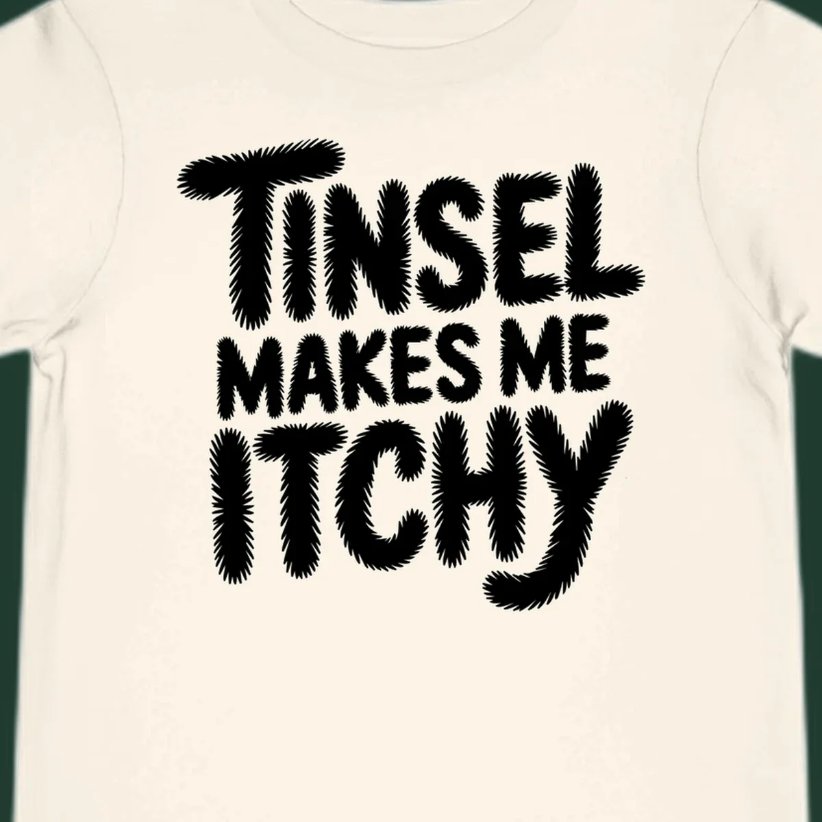 Text design reading "Tinsel Makes Me Itchy" in a fuzzy font.