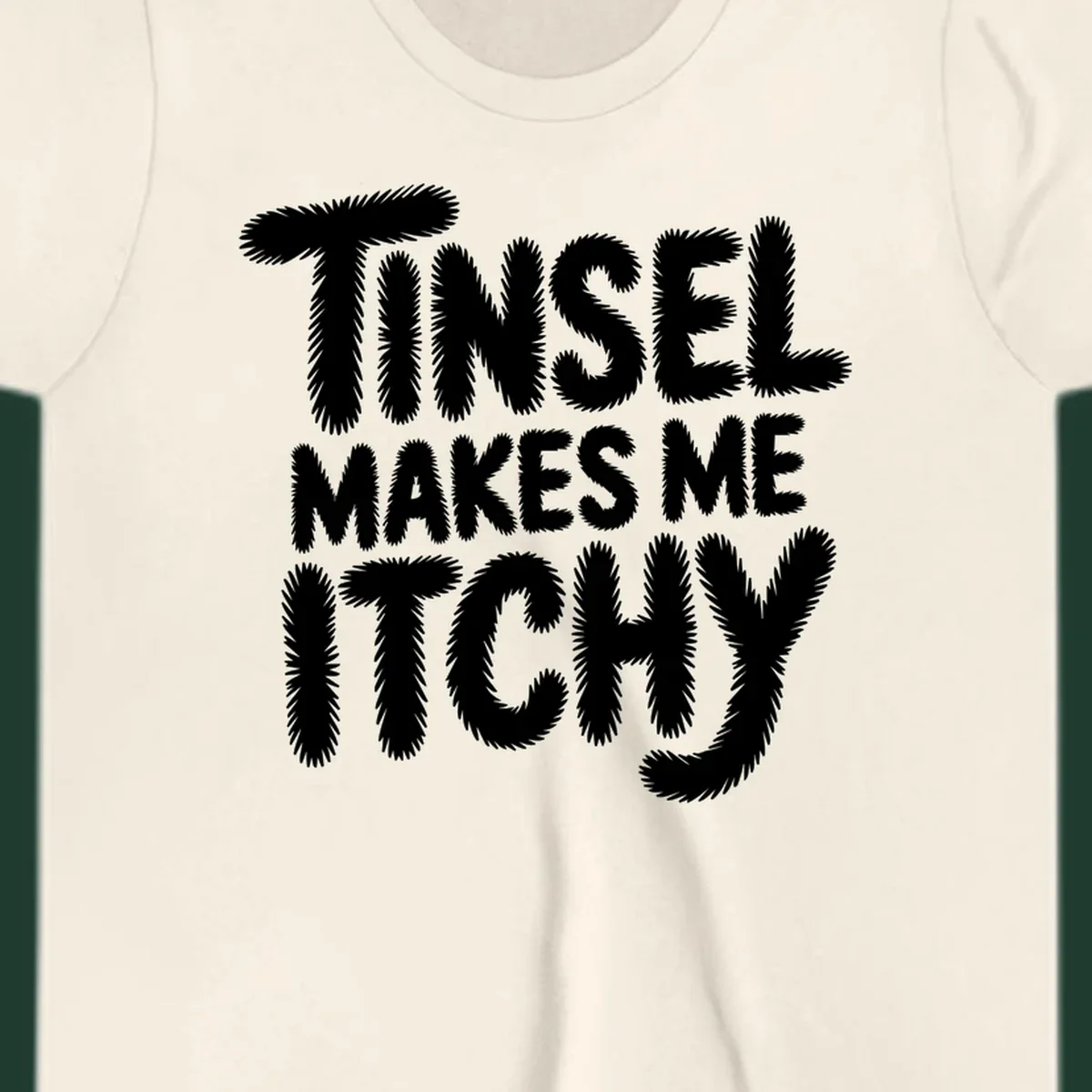 Text design reading "Tinsel Makes Me Itchy" in a fuzzy font.