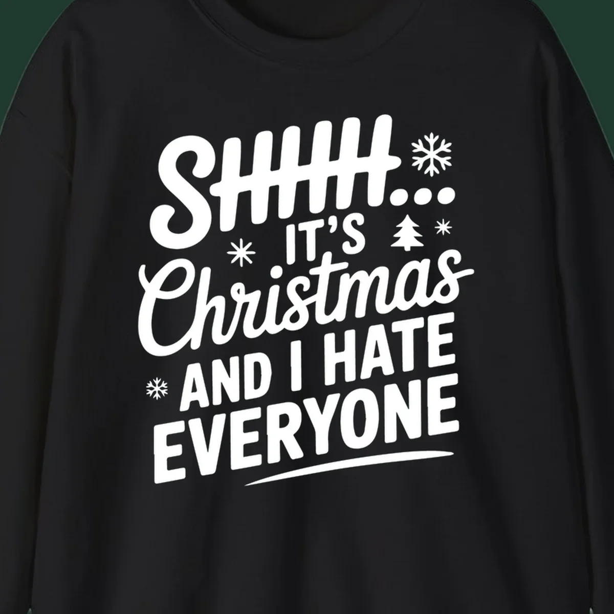 Shhh It's Christmas And I Hate Everyone text design with snowflake and tree graphics.