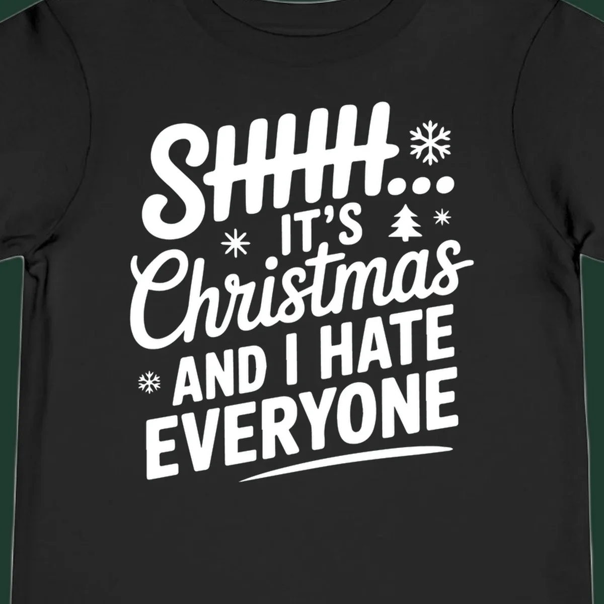 Shhh It's Christmas And I Hate Everyone text design with snowflake and tree graphics.