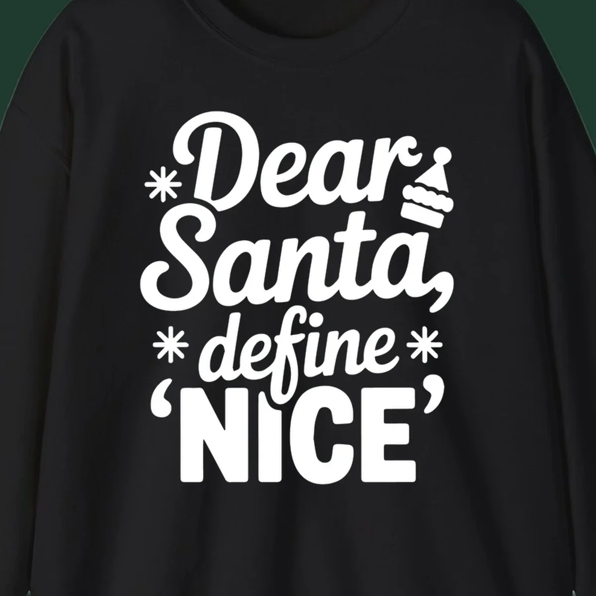 Black t-shirt design with white text asking 'Dear Santa, define NICE', accented by snowflakes and a Santa hat.