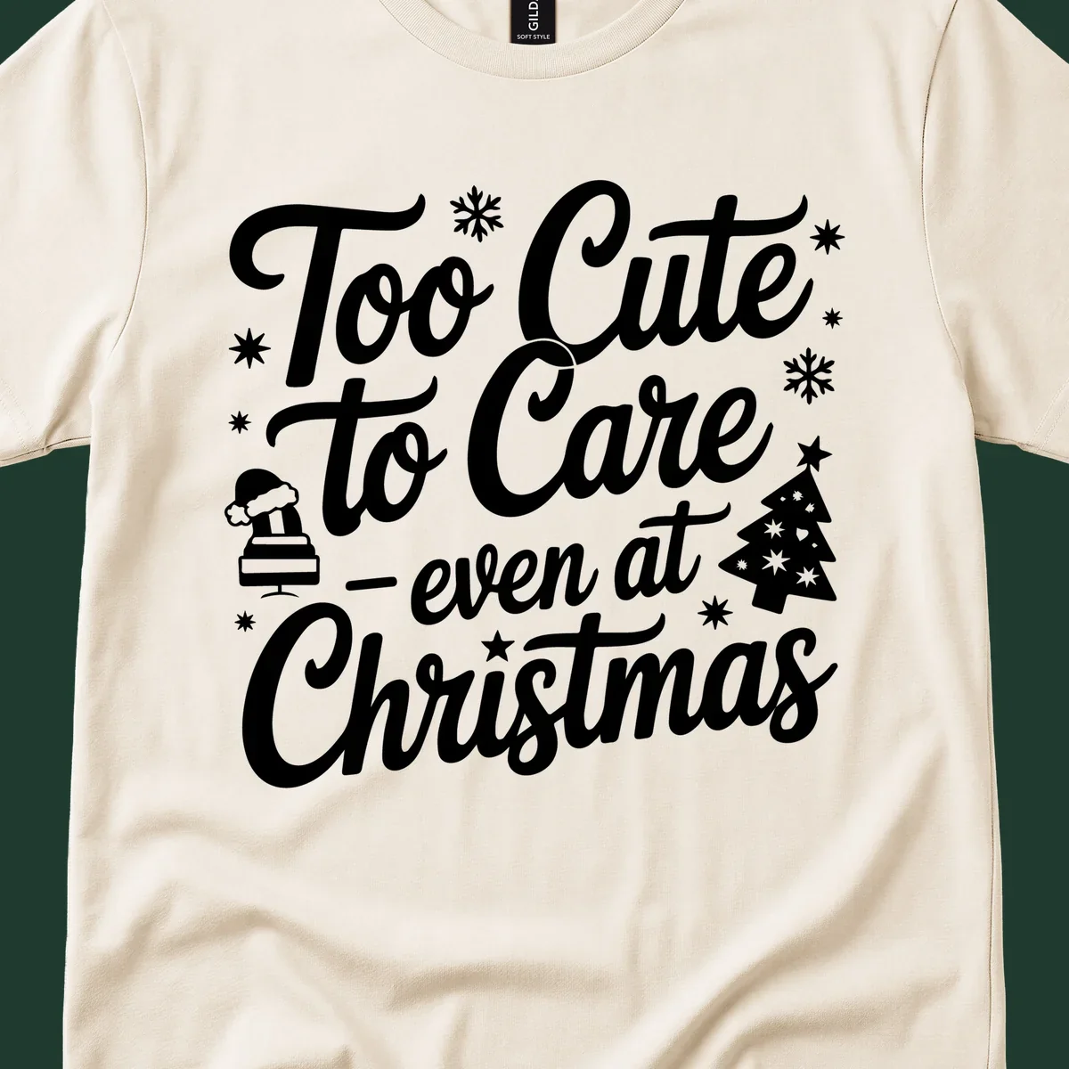 White text design 'Too Cute to Care - even at Christmas' with snowflakes, a tree, and Santa hat.