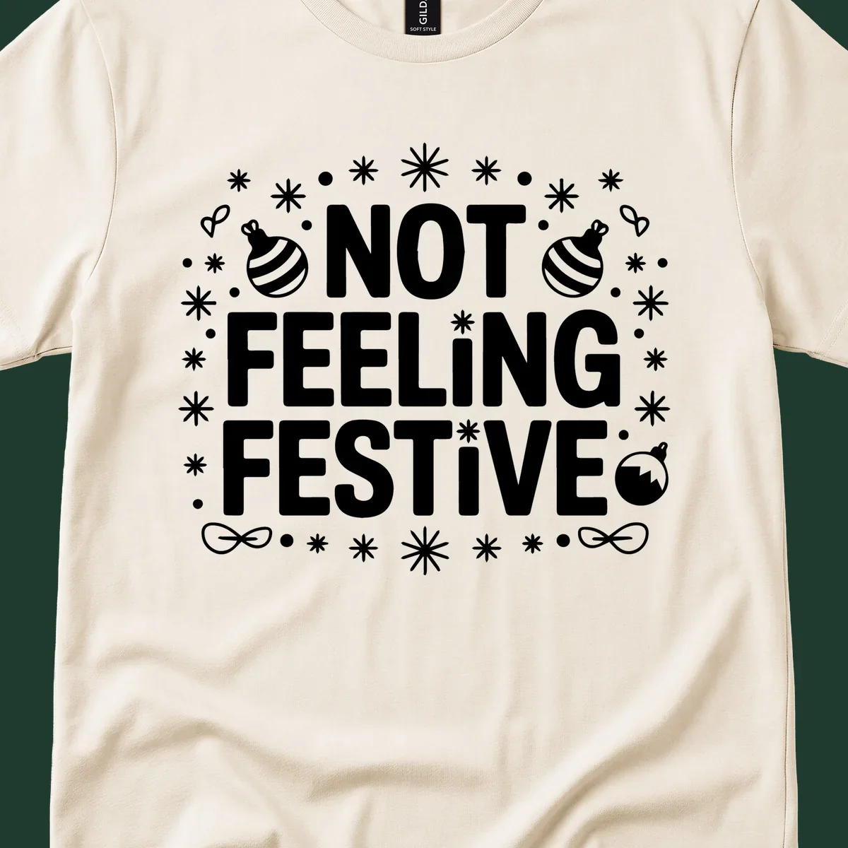 Not feeling festive graphic tee with text and winter elements.