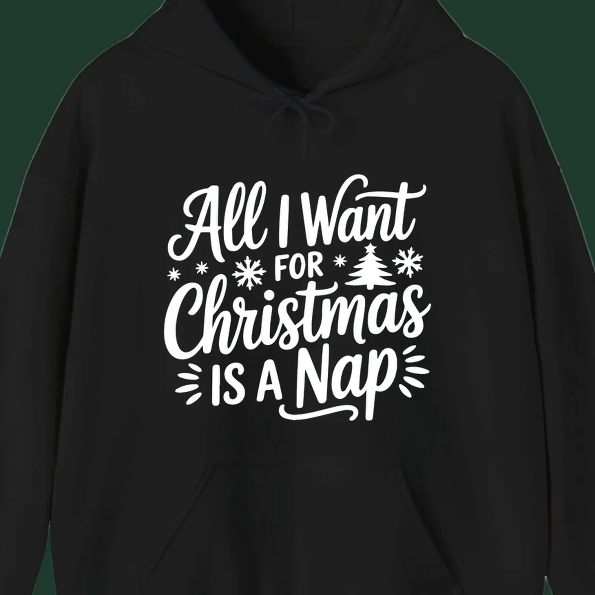 All I Want For Christmas Is A Nap typographic design with snowflakes and a Christmas tree.