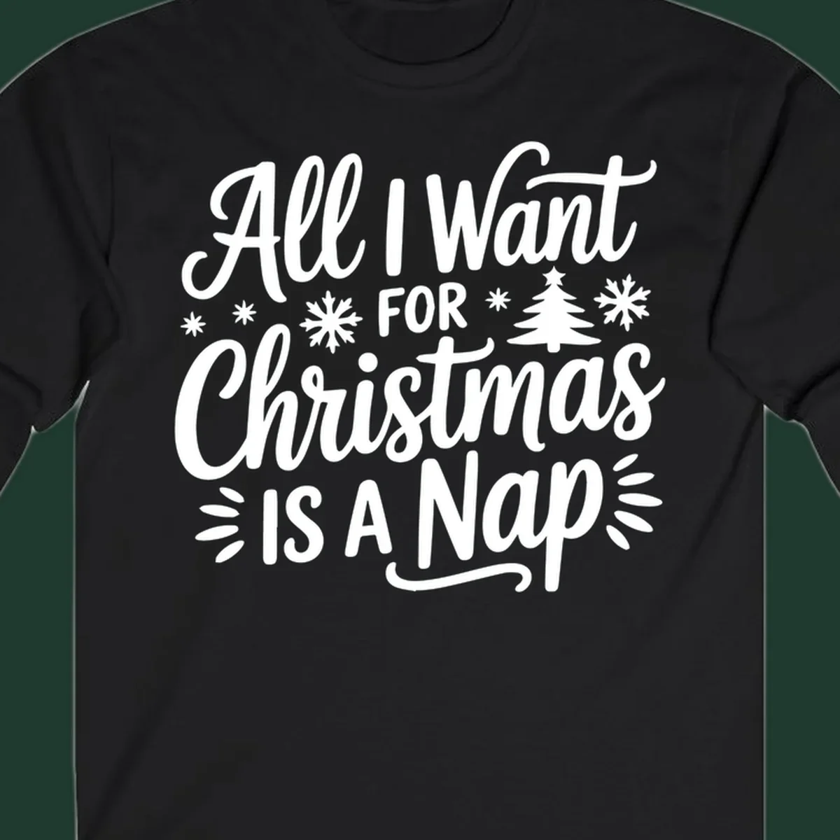 All I Want For Christmas Is A Nap typographic design with snowflakes and a Christmas tree.