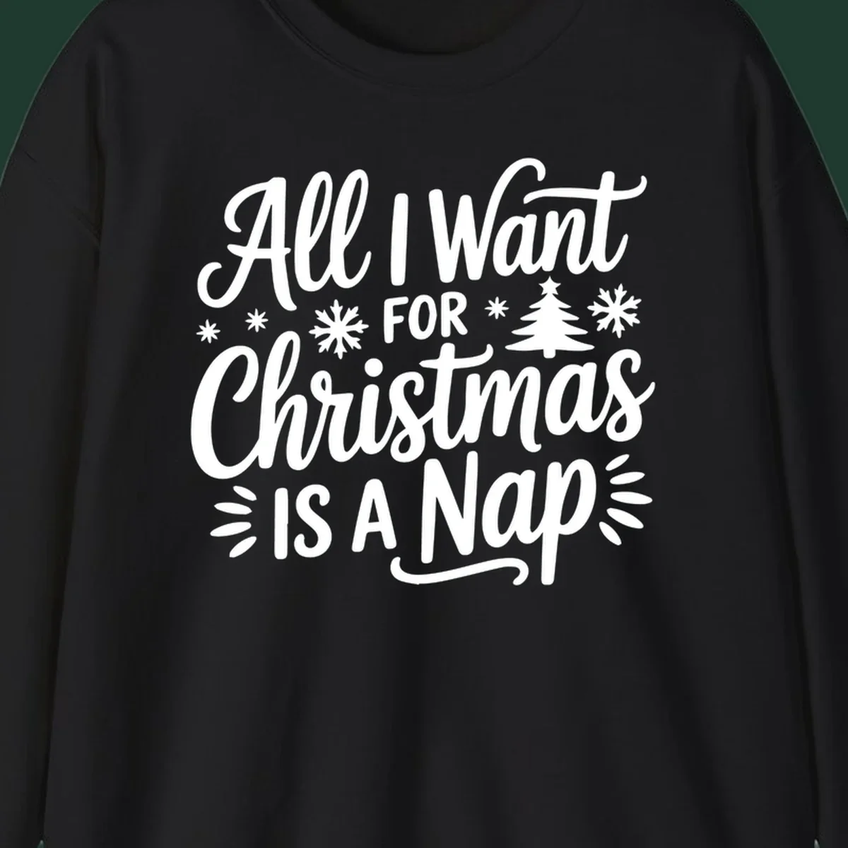 All I Want For Christmas Is A Nap typographic design with snowflakes and a Christmas tree.