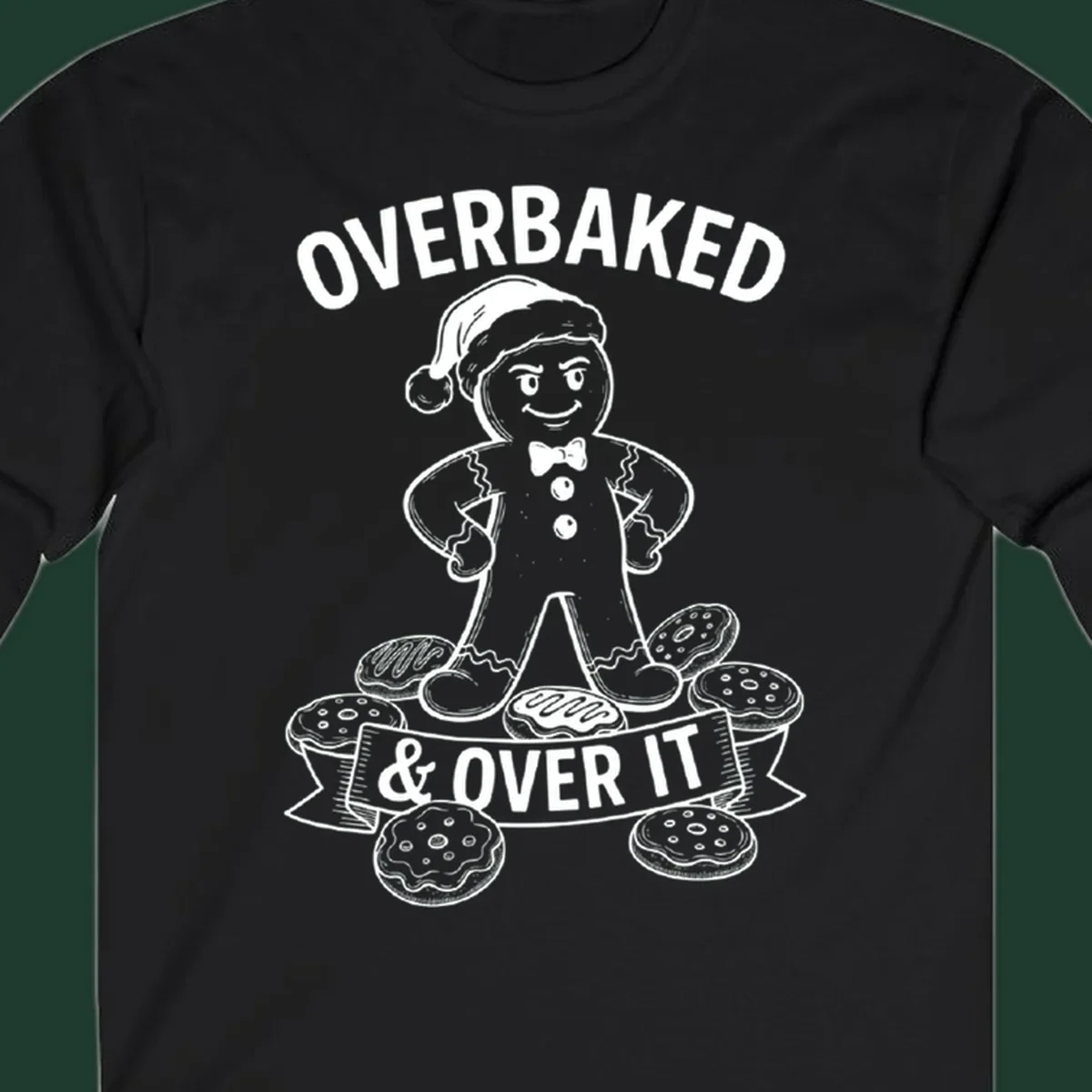Overbaked gingerbread man with Santa hat and cookies, text says OVERBAKED & OVER IT.