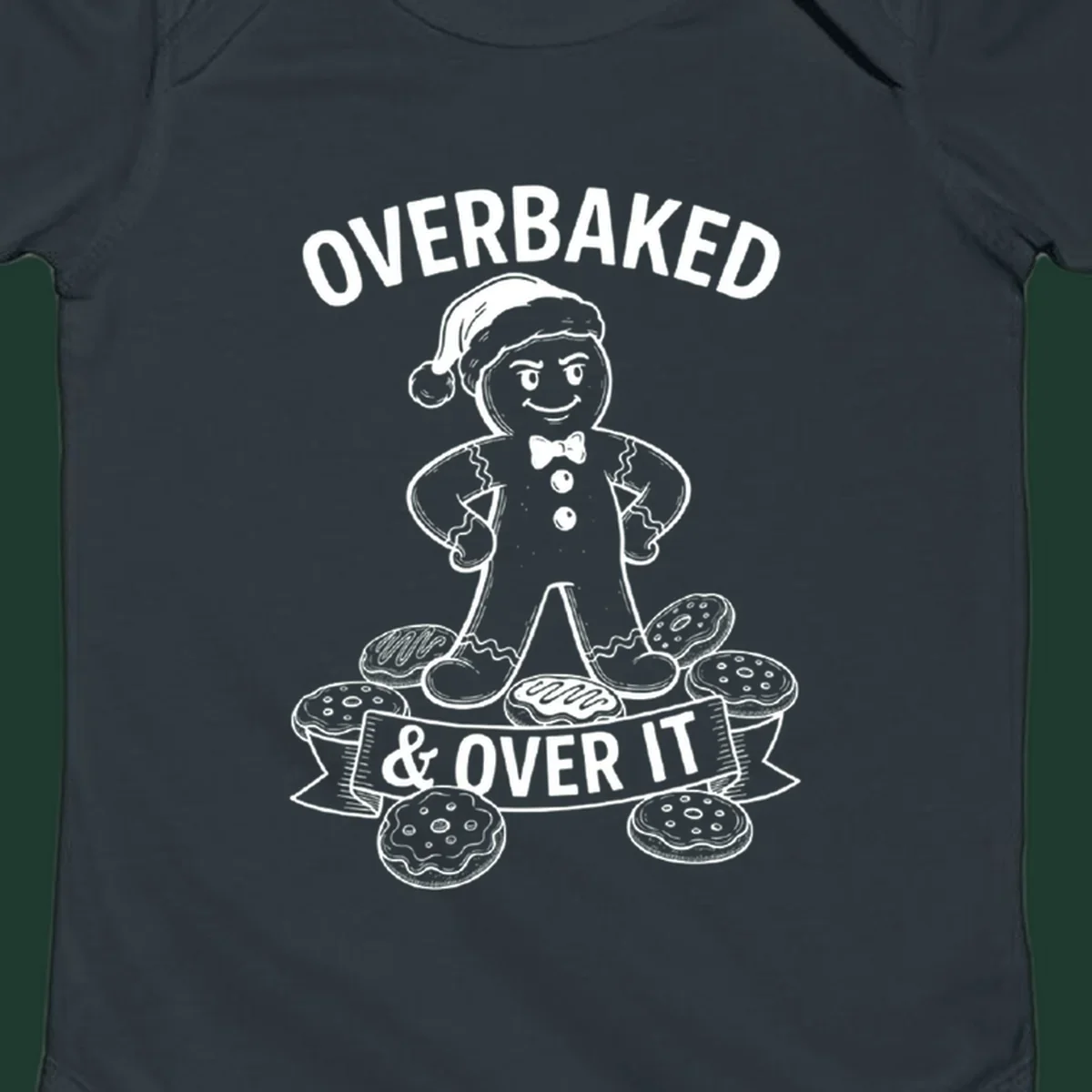 Overbaked gingerbread man with Santa hat and cookies, text says OVERBAKED & OVER IT.