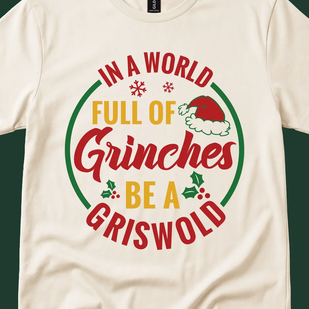 Circular design with text 'In A World Full Of Grinches Be A Griswold', snowflakes, Santa hat, and holly. Christmas graphic.