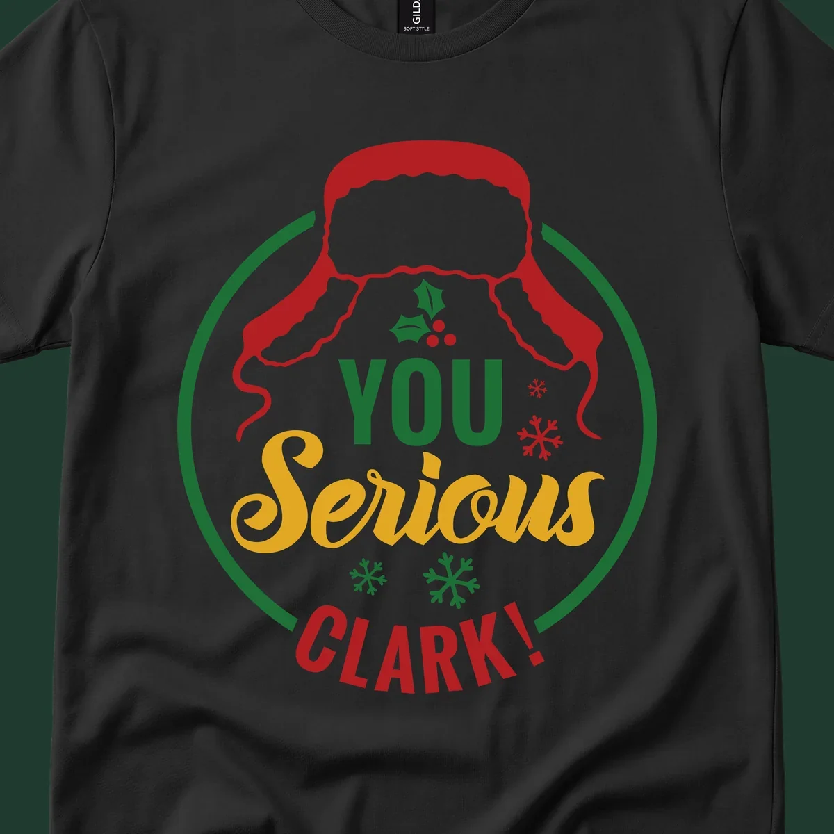 Christmas Clark quote graphic with a hat, holly, and snowflakes.