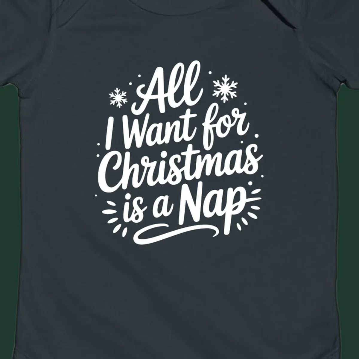 All I Want for Christmas Is A Nap typography design with snowflakes.