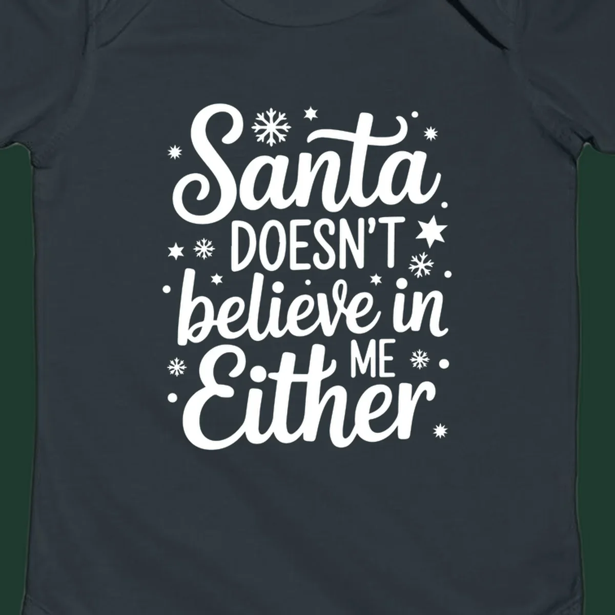 Typography design that reads Santa DOESN'T believe in ME Either, with snowflakes and stars.