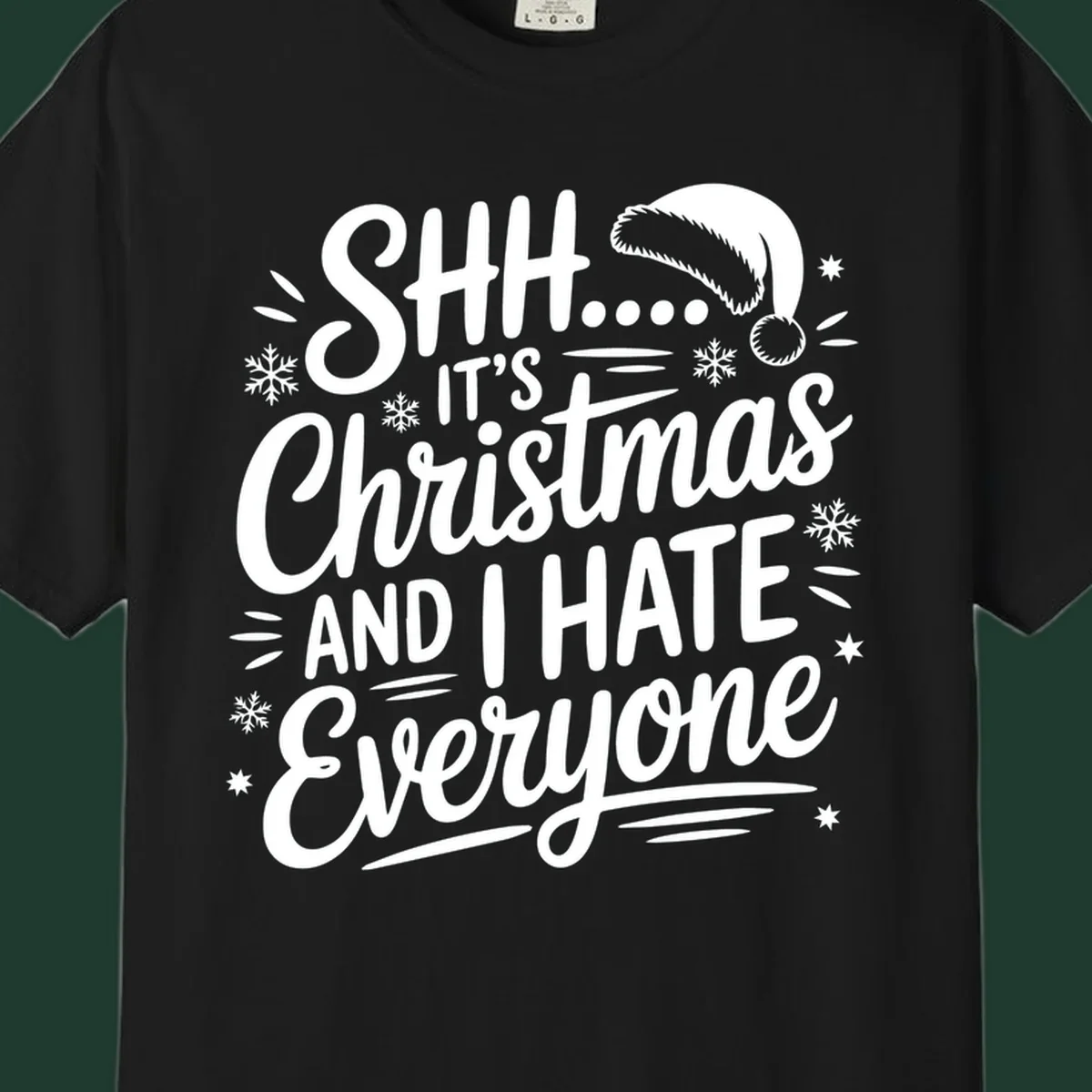 Shh it's Christmas And I Hate Everyone typography with Santa hat, snowflakes, and stars.