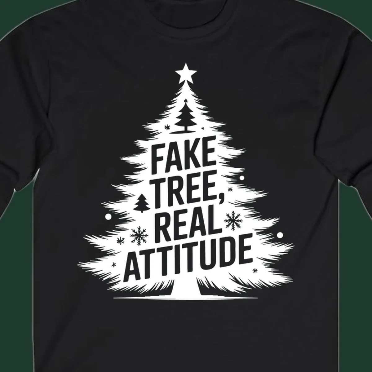 Christmas tree graphic with text 'FAKE TREE, REAL ATTITUDE' and snowflake accents.