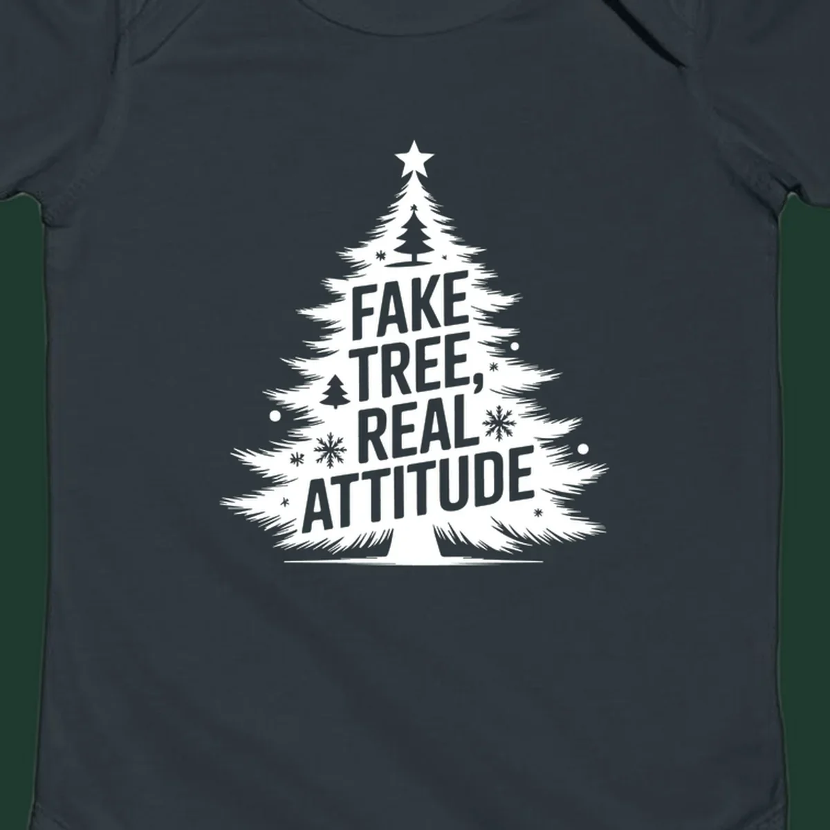 Christmas tree graphic with text 'FAKE TREE, REAL ATTITUDE' and snowflake accents.