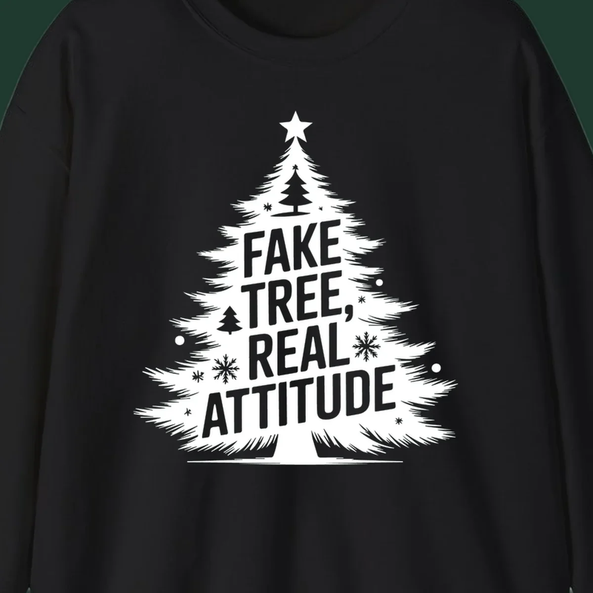 Christmas tree graphic with text 'FAKE TREE, REAL ATTITUDE' and snowflake accents.