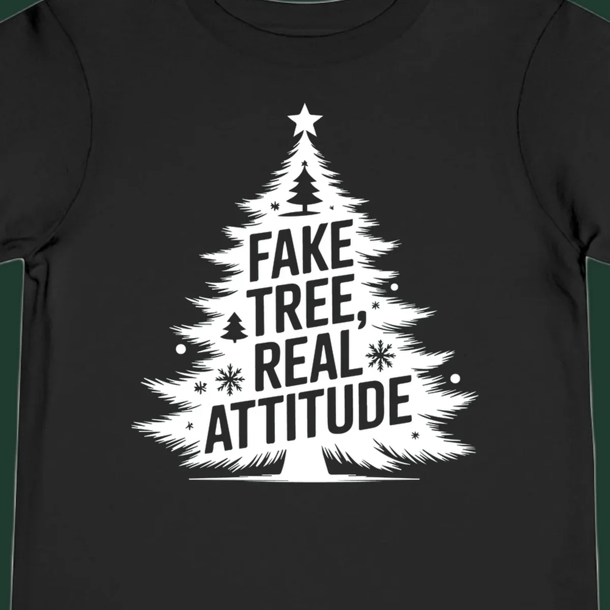 Christmas tree graphic with text 'FAKE TREE, REAL ATTITUDE' and snowflake accents.