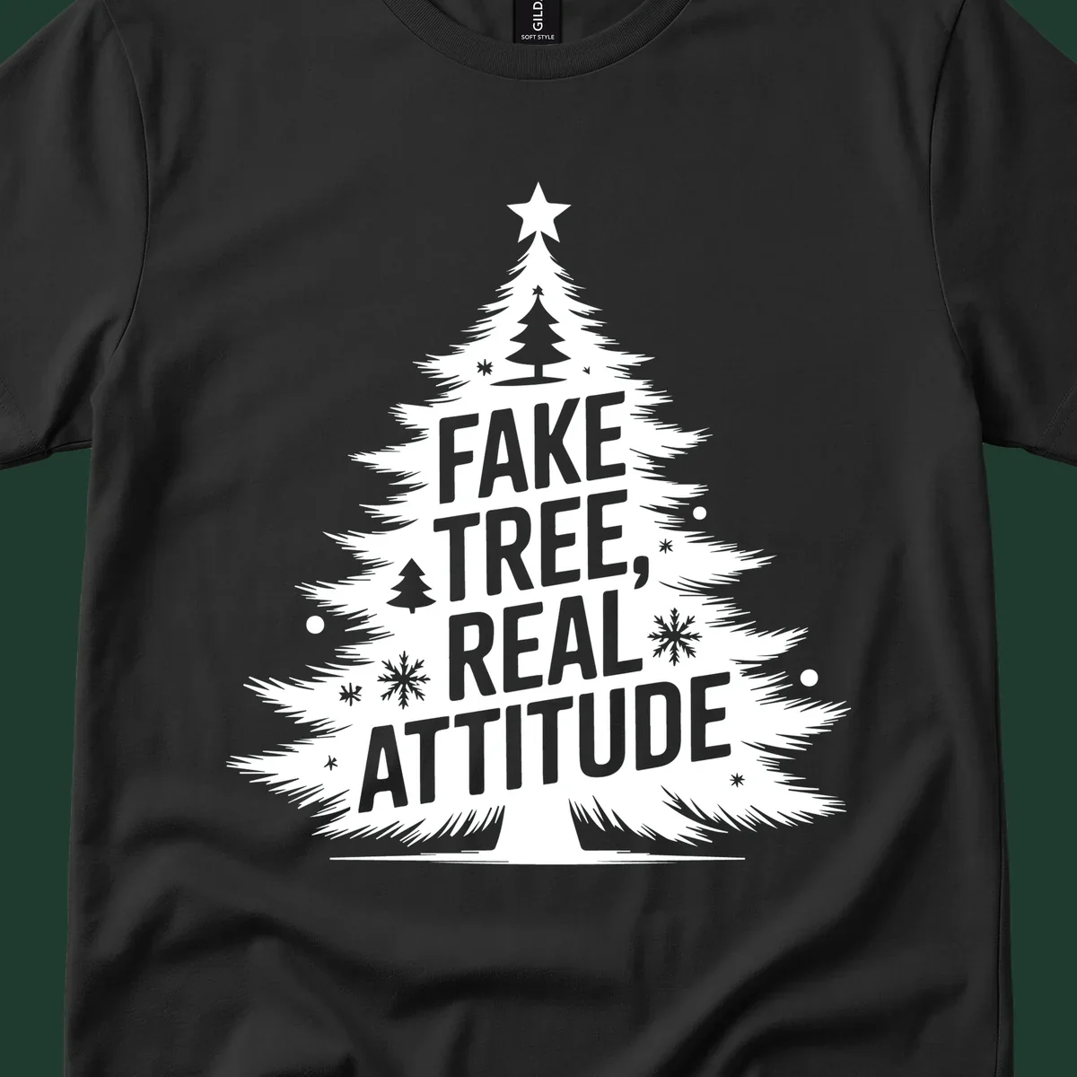 Christmas tree graphic with text 'FAKE TREE, REAL ATTITUDE' and snowflake accents.