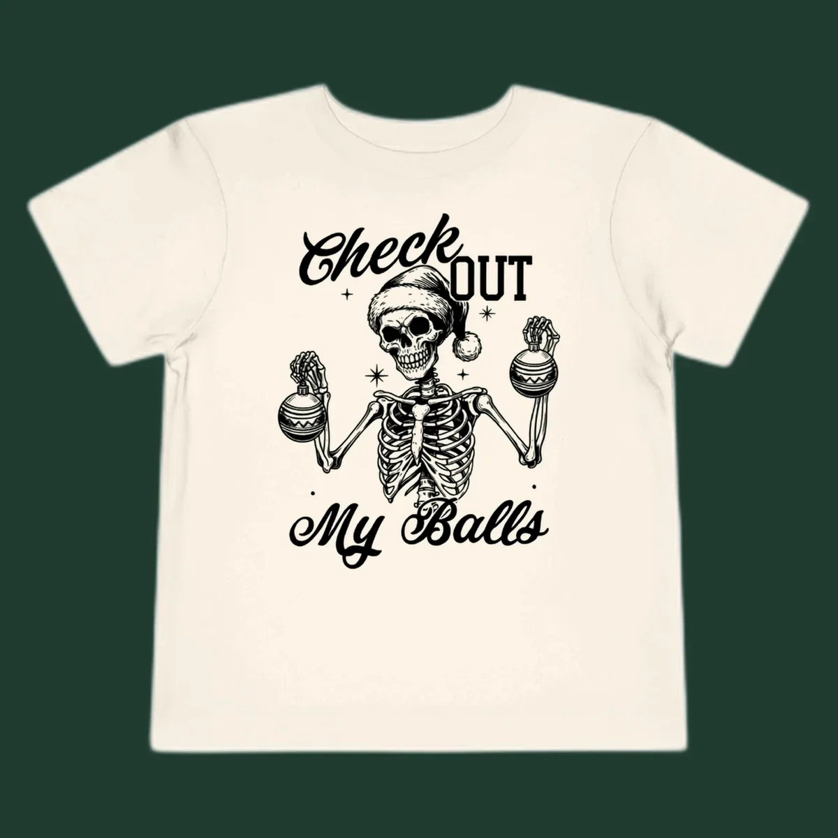 Skeleton wearing a Santa hat and holding Christmas ornaments, with text 'Check OUT My Balls'.