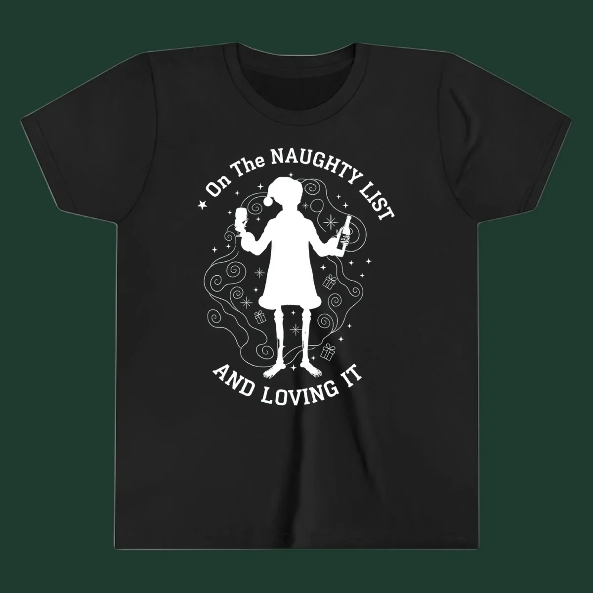 Silhouette of person in Santa hat holding wine, text 'Naughty List And Loving It'.