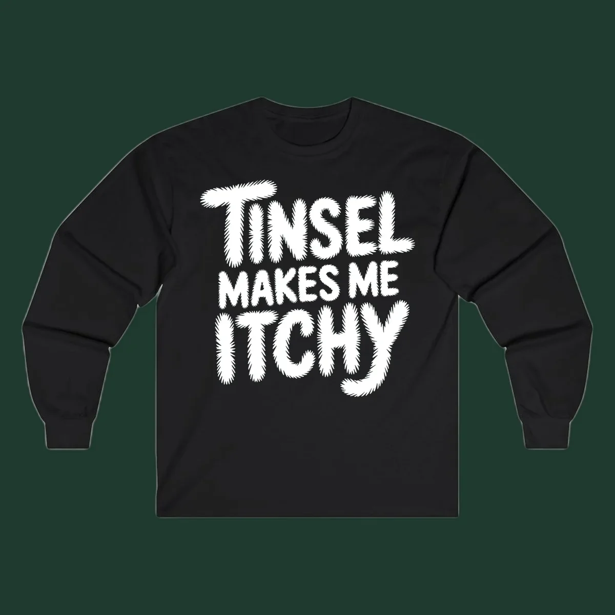 Text design reading "Tinsel Makes Me Itchy" in a fuzzy font.