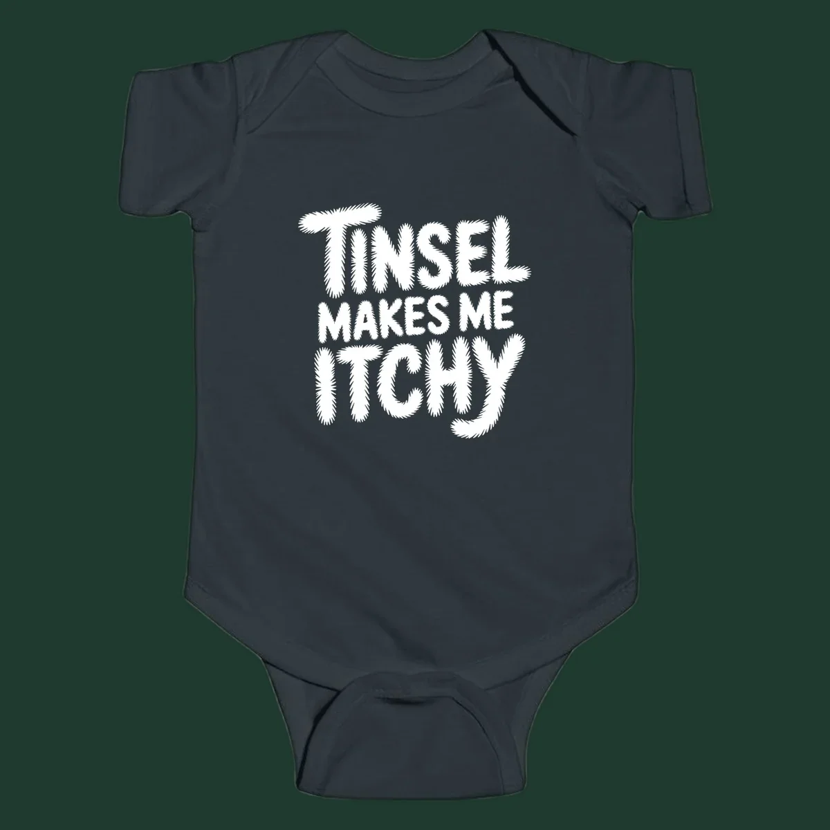 Text design reading "Tinsel Makes Me Itchy" in a fuzzy font.