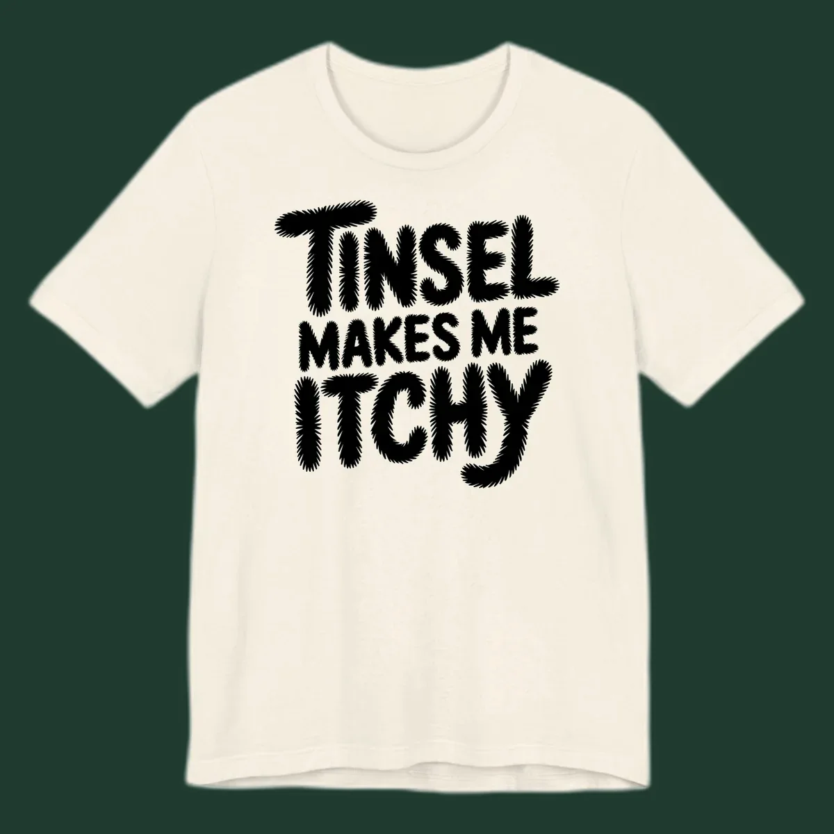 Text design reading "Tinsel Makes Me Itchy" in a fuzzy font.